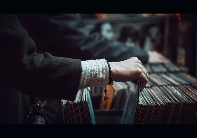 Hands browsing a retail shelf