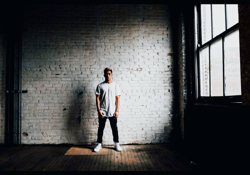Person standing in a brick warehouse