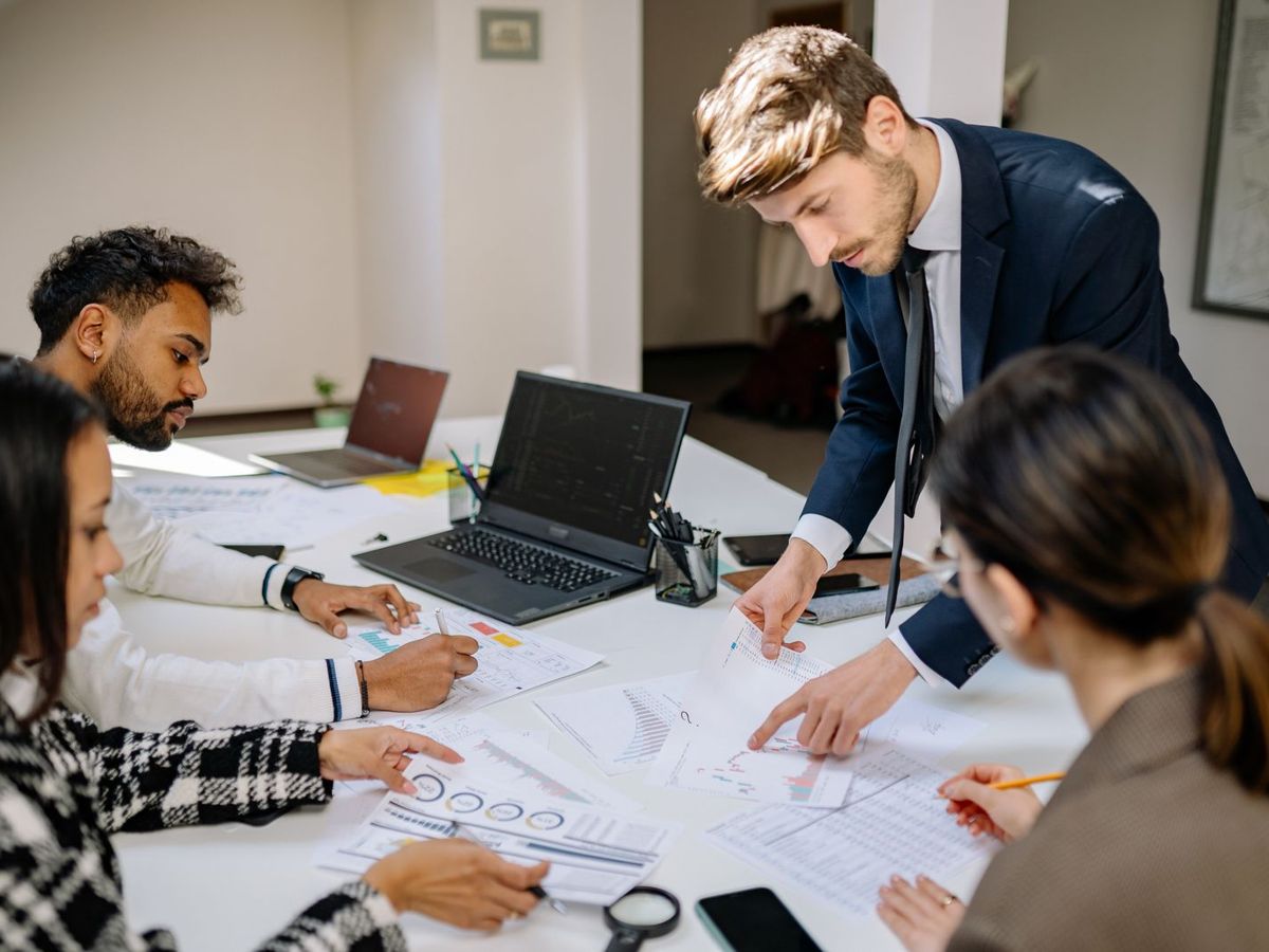 A small finance team reviewing reports together